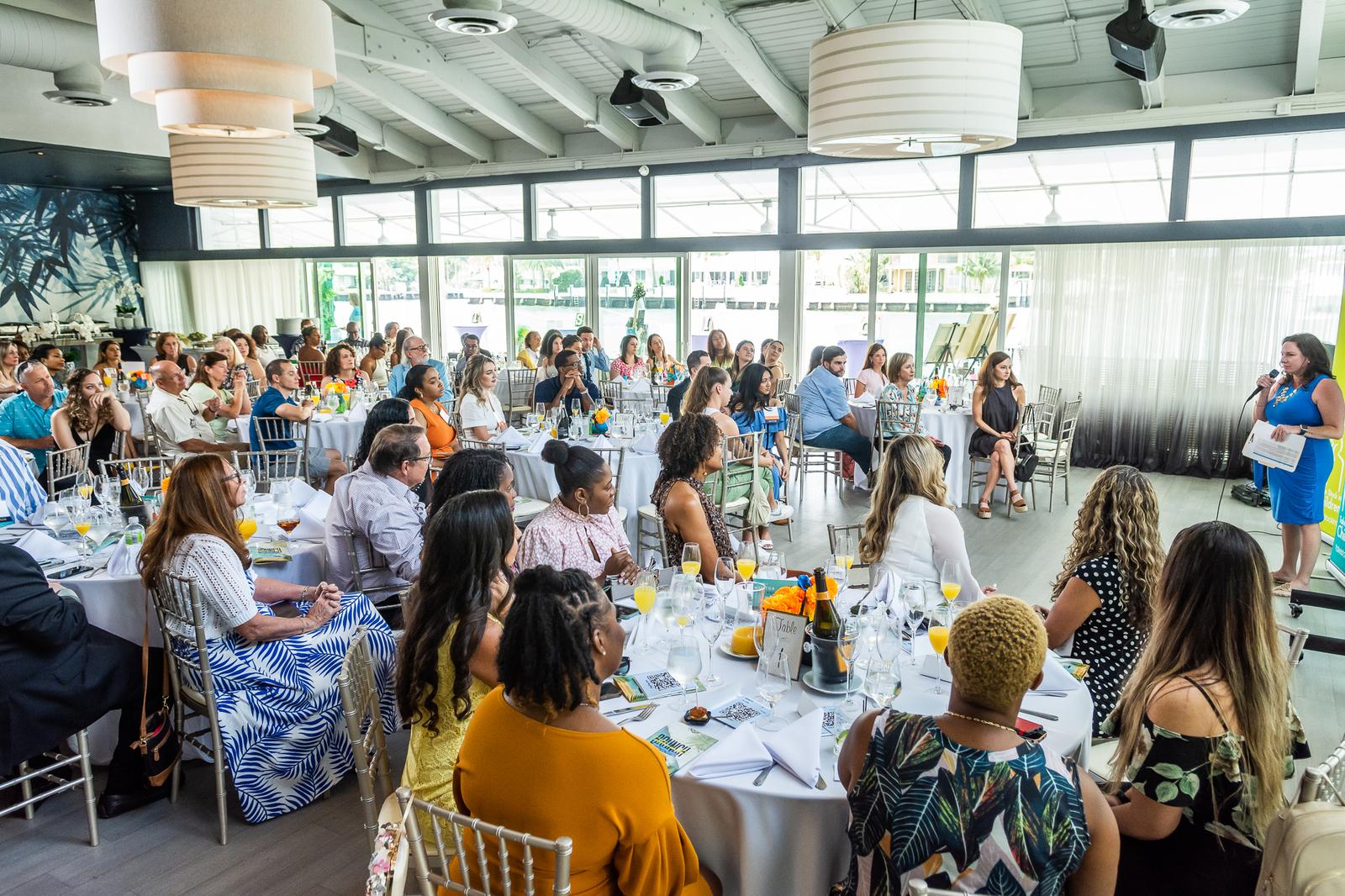 A full room of supporters seated at tables at a Take Stock in Children of Broward fundraiser
