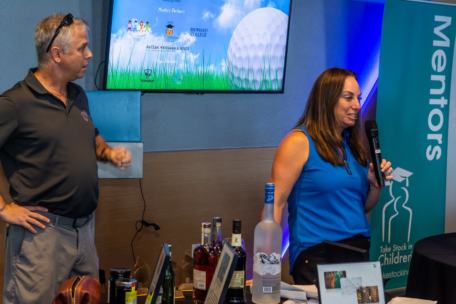 A young woman in a blazer smiling at a Take Stock in Children of Broward event