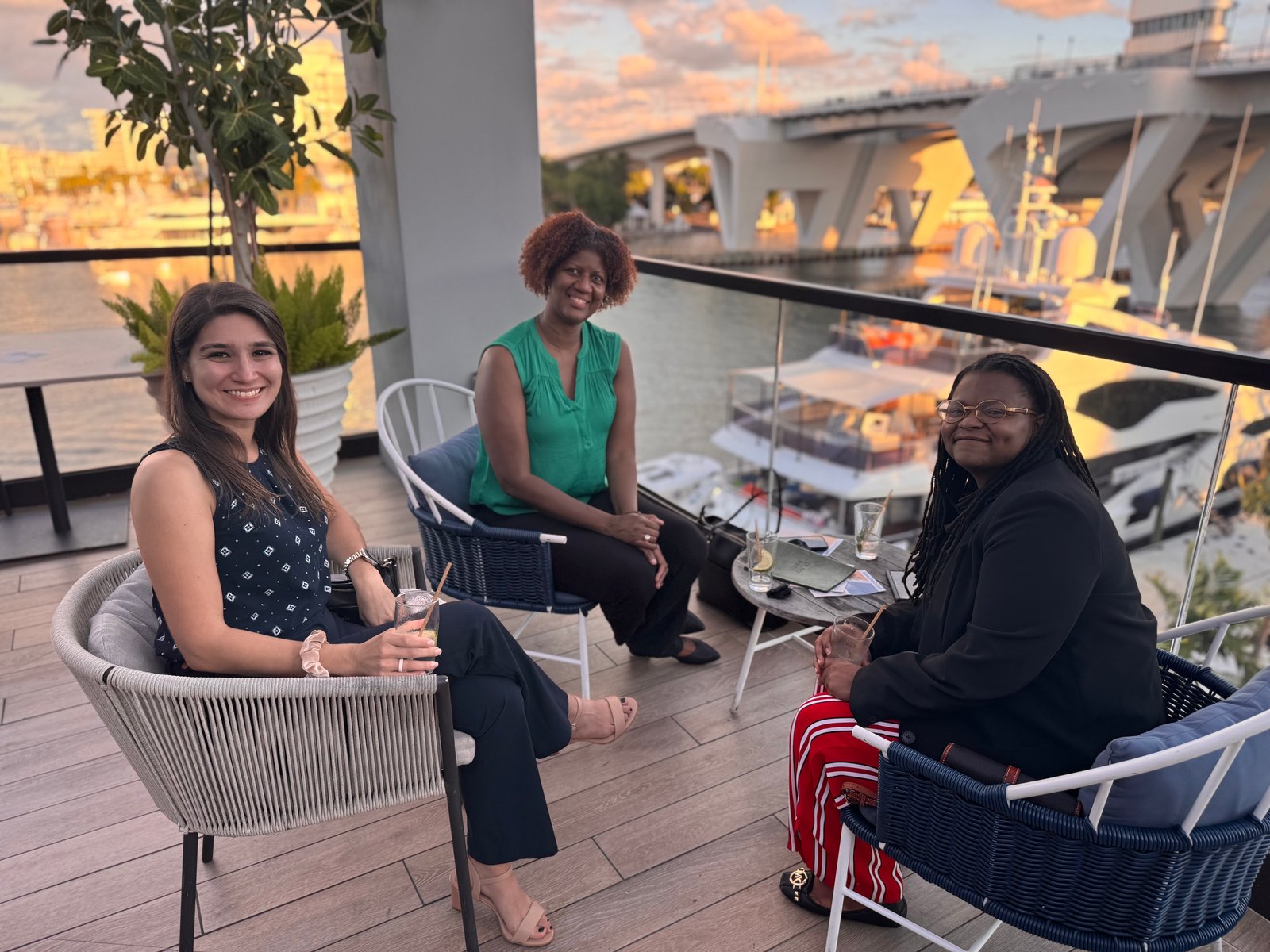 Guests seated on a waterfront terrace at a Take Stock event