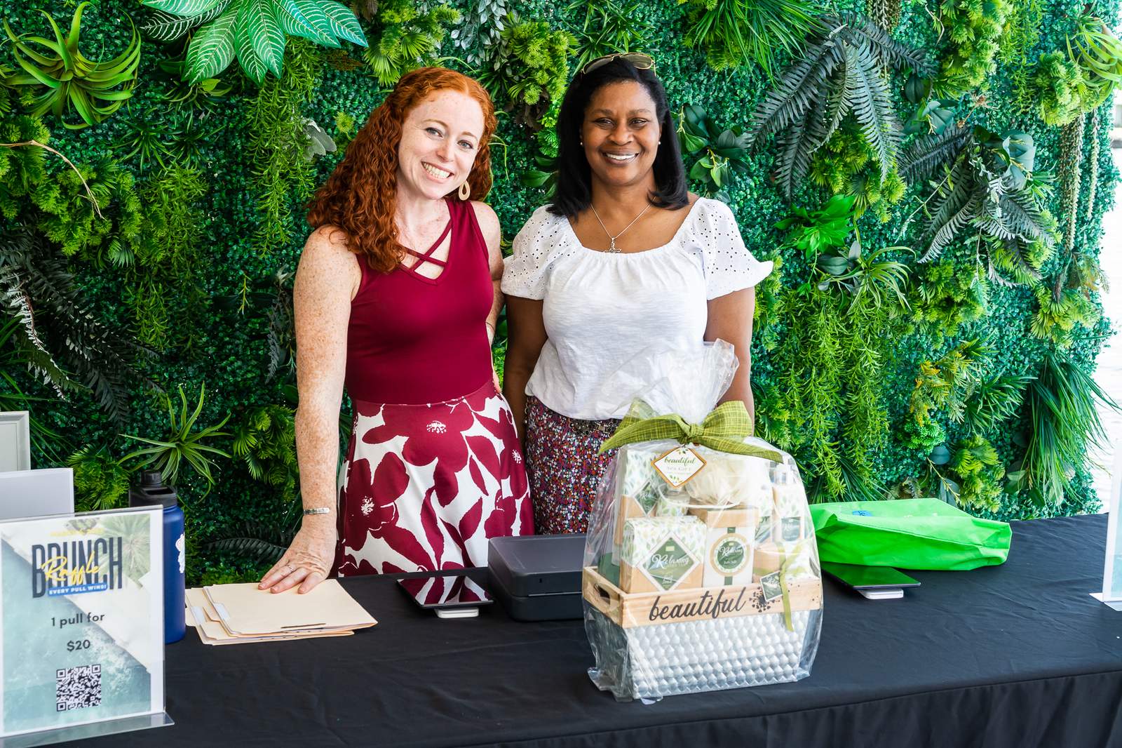Two volunteers at a gift table at a Take Stock in Children event