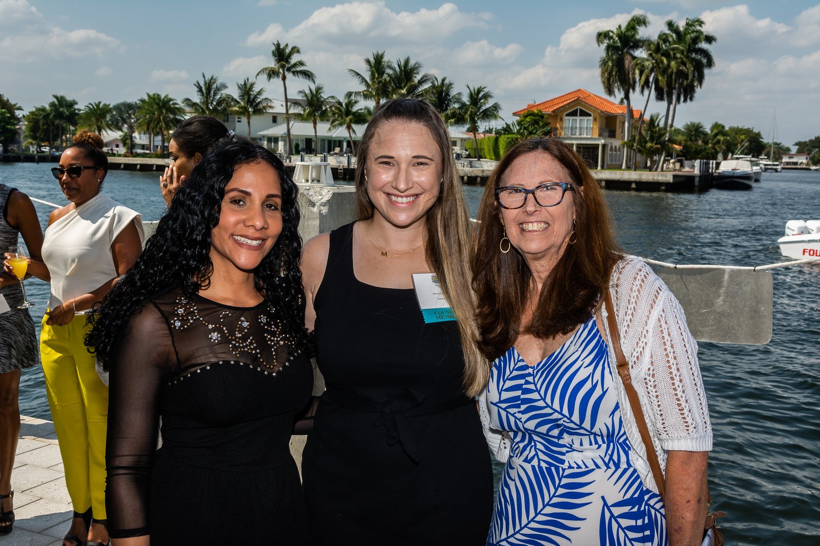 Three guests on the waterfront at a Take Stock in Children fundraiser