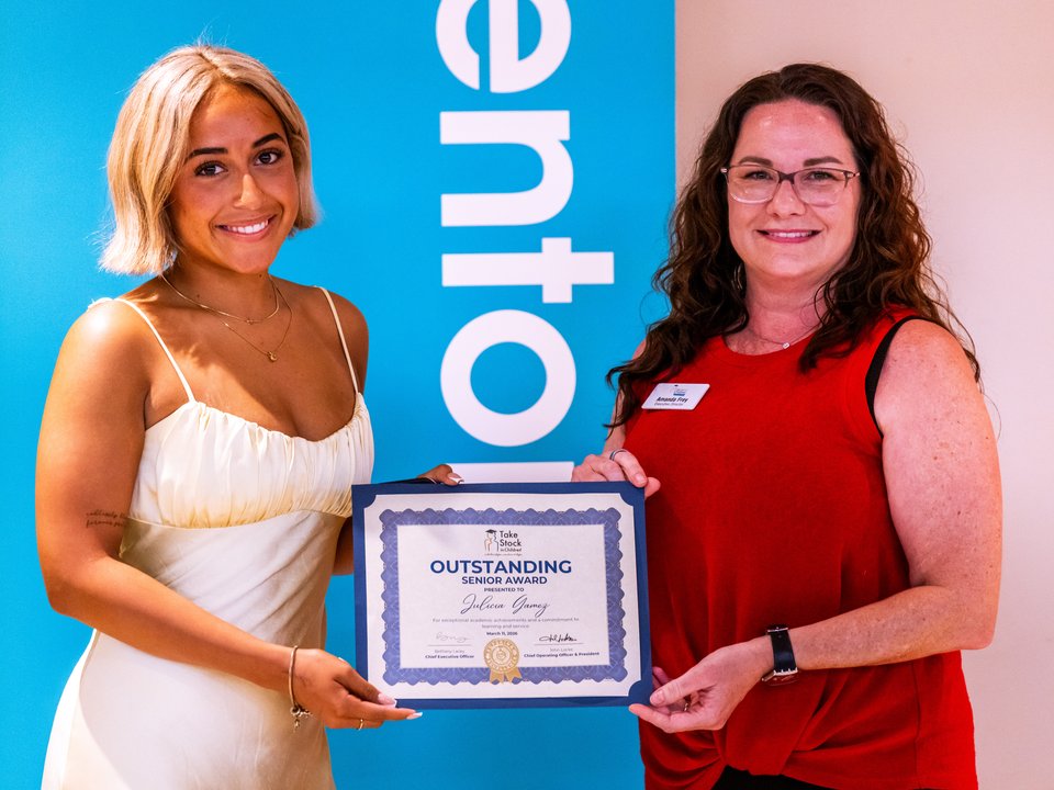 Executive Director Amanda Frey presenting the Outstanding Senior Award to a graduating scholar