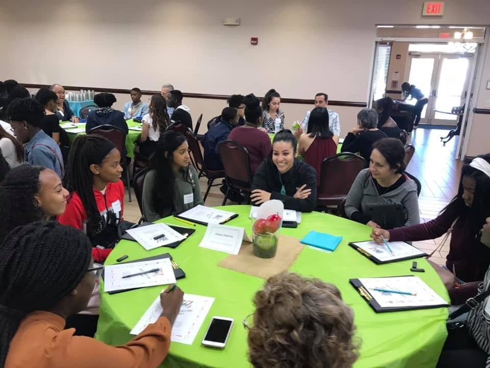 Scholars and mentors participating in an interactive leadership roundtable